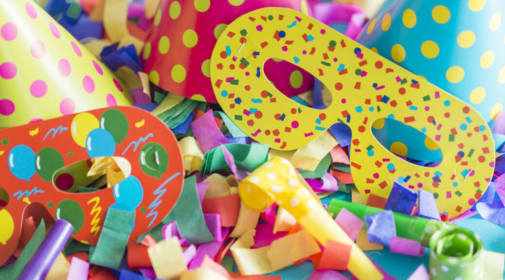 Symbolbild für Fasching: bunte Maske und Luftschlangen.